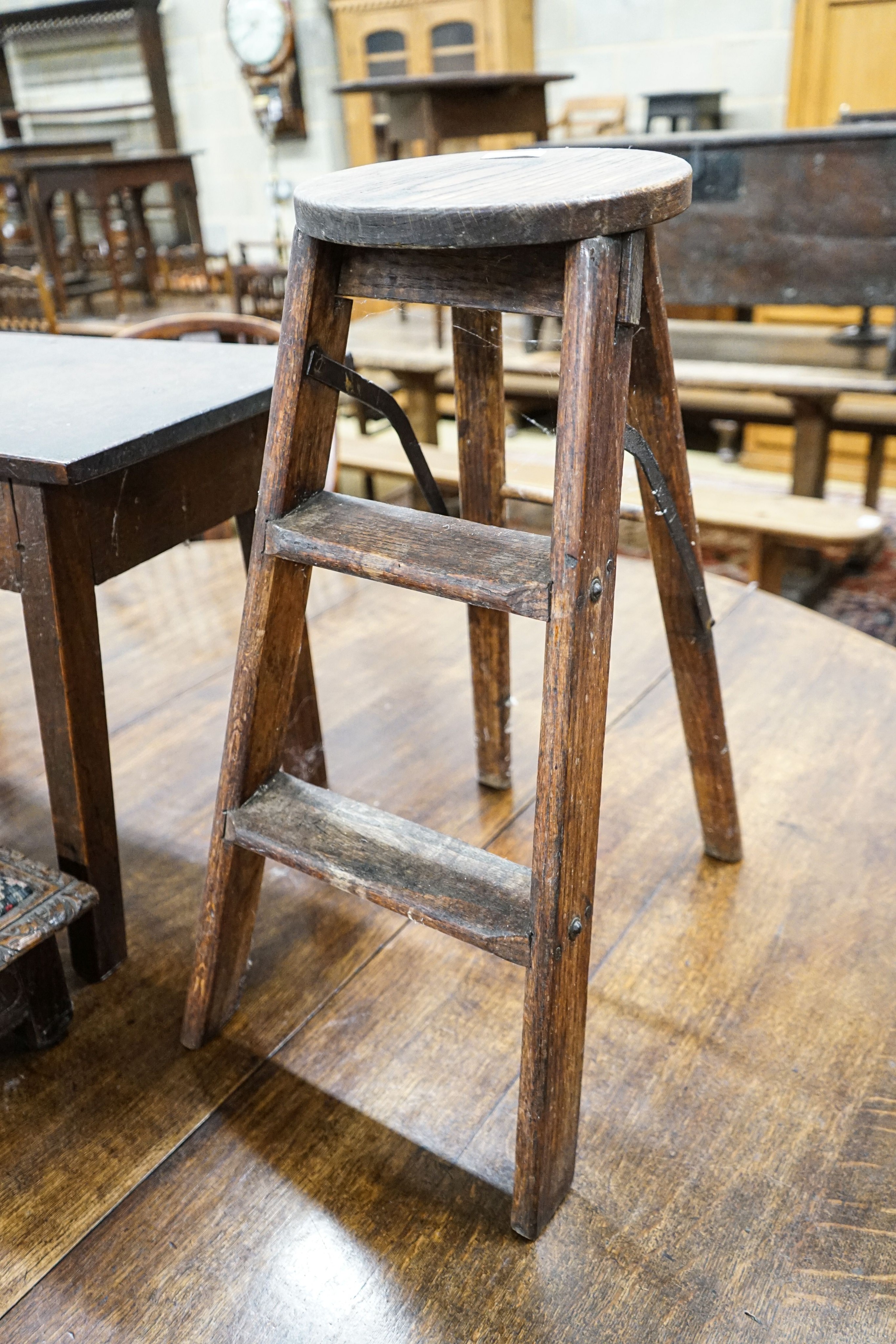 An 18th century oak low table, width 74cm, height 32cm, a carved oak foot stool and an Edwardian oak folding steps stool